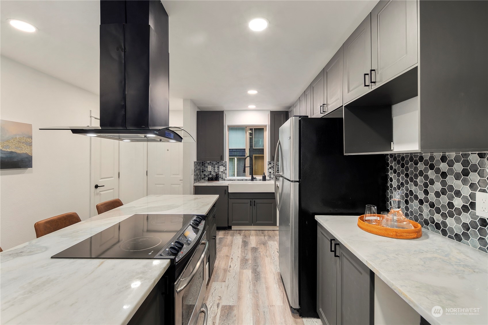7307 Sand Point Way Northeast, Unit B618 Seattle, WA 98115 - Photo 9 of 23 a kitchen with kitchen island granite countertop a sink a stove and a refrigerator