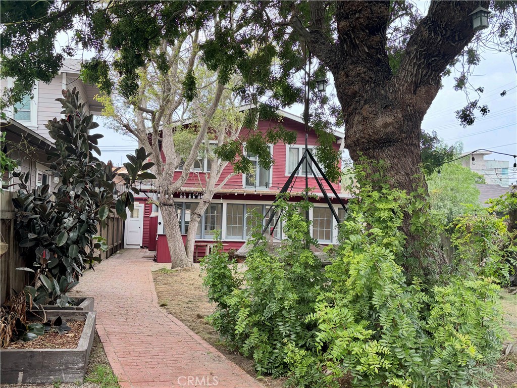 a front view of house with yard and trees around