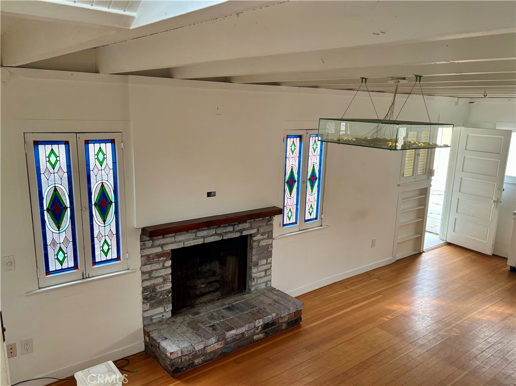 25 Galleon Street Marina del Rey, CA 90292 - Photo 9 of 41 a living room with hard wood floors and a fireplace