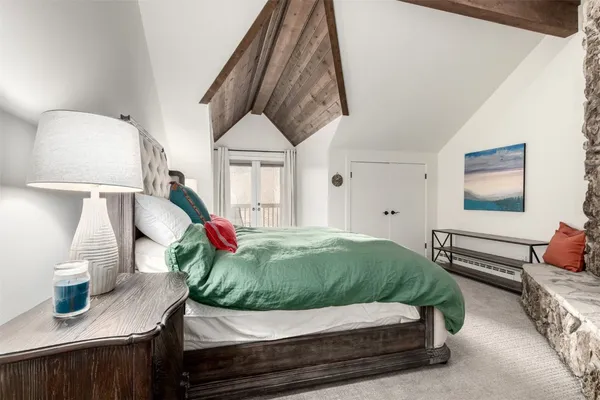 a bedroom with a bed and a fireplace