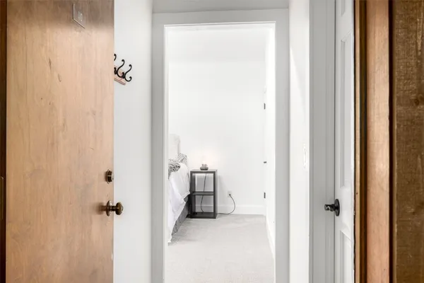 a view of a hallway with wooden floor