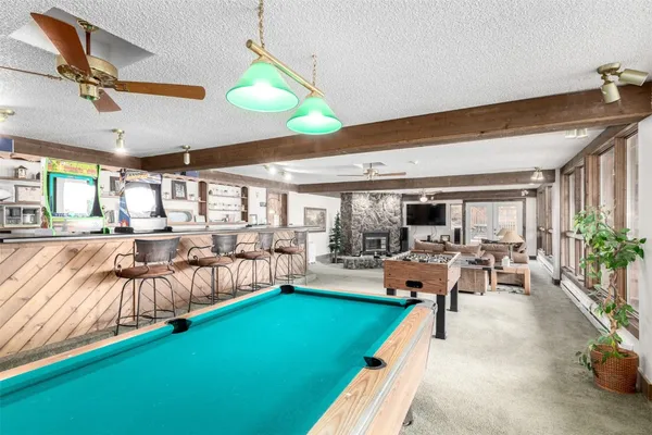 a dining room with furniture and large windows