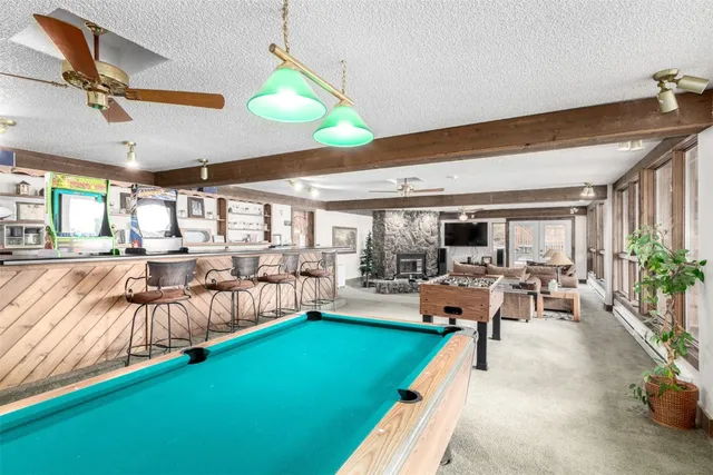 a dining room with furniture and large windows