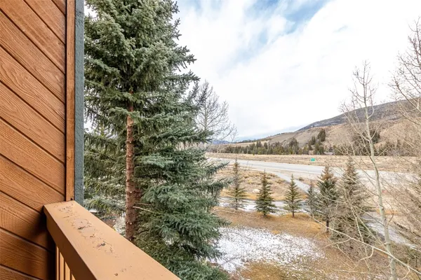 a view of a roof deck with table and chairs with wooden floor and fence