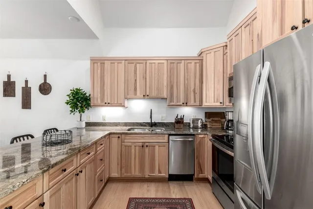 a kitchen with a sink stove and refrigerator