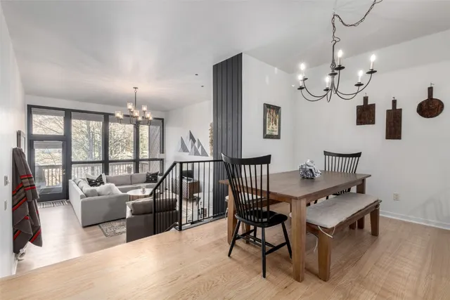 a view of a livingroom with furniture and a floor to ceiling window