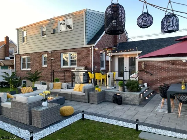 a view of an house with backyard and patio