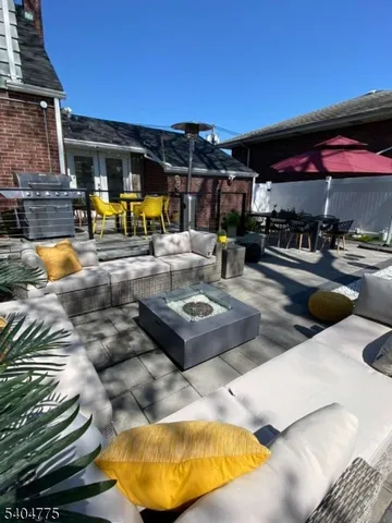 a swimming pool with outdoor seating and a potted plants