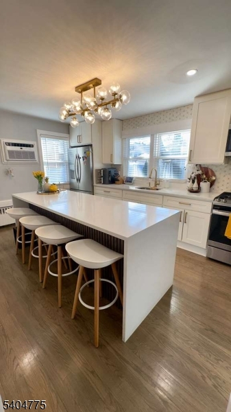 120 Union Street Lodi, NJ 07644 - Photo 3 of 18 a large kitchen with kitchen island a large island in the center and stainless steel appliances