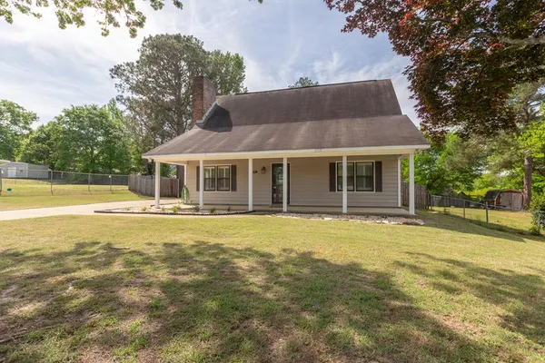 a view of a house with a swimming pool and a yard