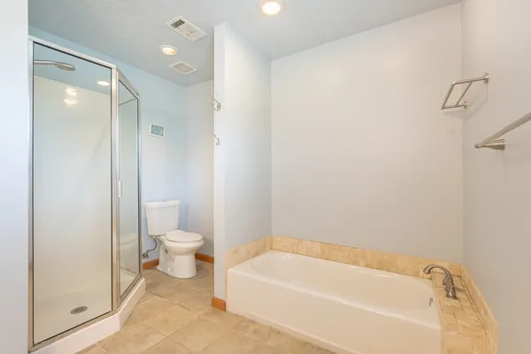 a bathroom with a bathtub and a toilet
