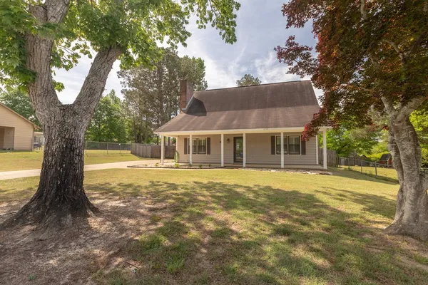 a front view of a house with a garden
