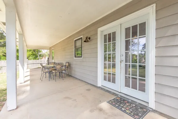 a dining room with furniture and a window