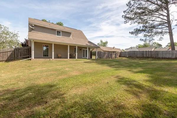 a view of a large building with swimming pool in front of it