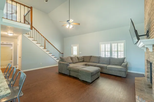 a living room with furniture and a chandelier