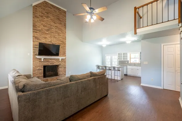 a living room with furniture a fireplace and a flat screen tv