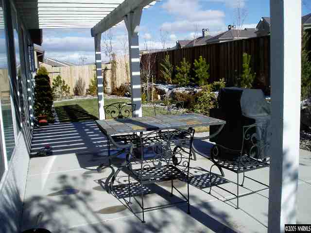 9918 Bridge View Drive Reno, NV 89521 - Photo 6 of 6 a view of a patio with table and chairs with wooden floor and fence
