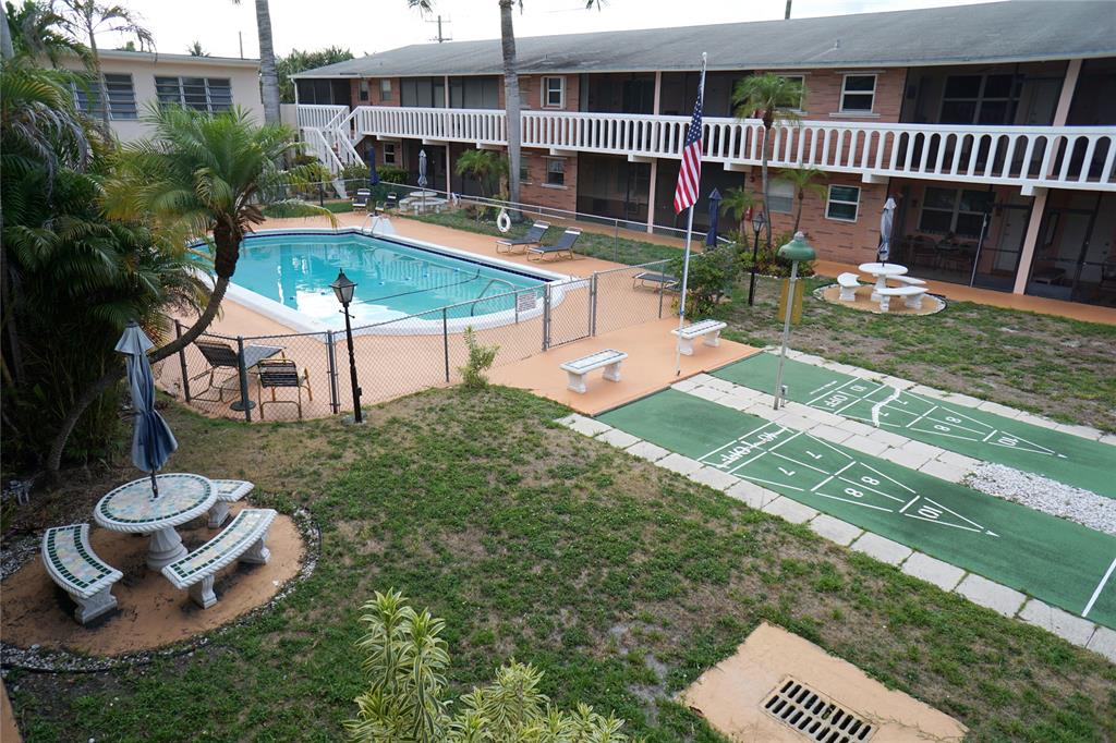 160 Northeast 8th Avenue, Unit 25B Hallandale Beach, FL 33009 - Photo 11 of 35 a view of a house with backyard and sitting area