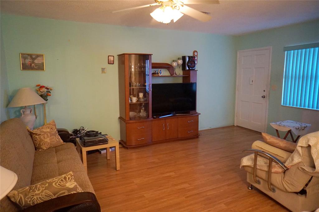 160 Northeast 8th Avenue, Unit 25B Hallandale Beach, FL 33009 - Photo 16 of 35 a living room with furniture and a flat screen tv