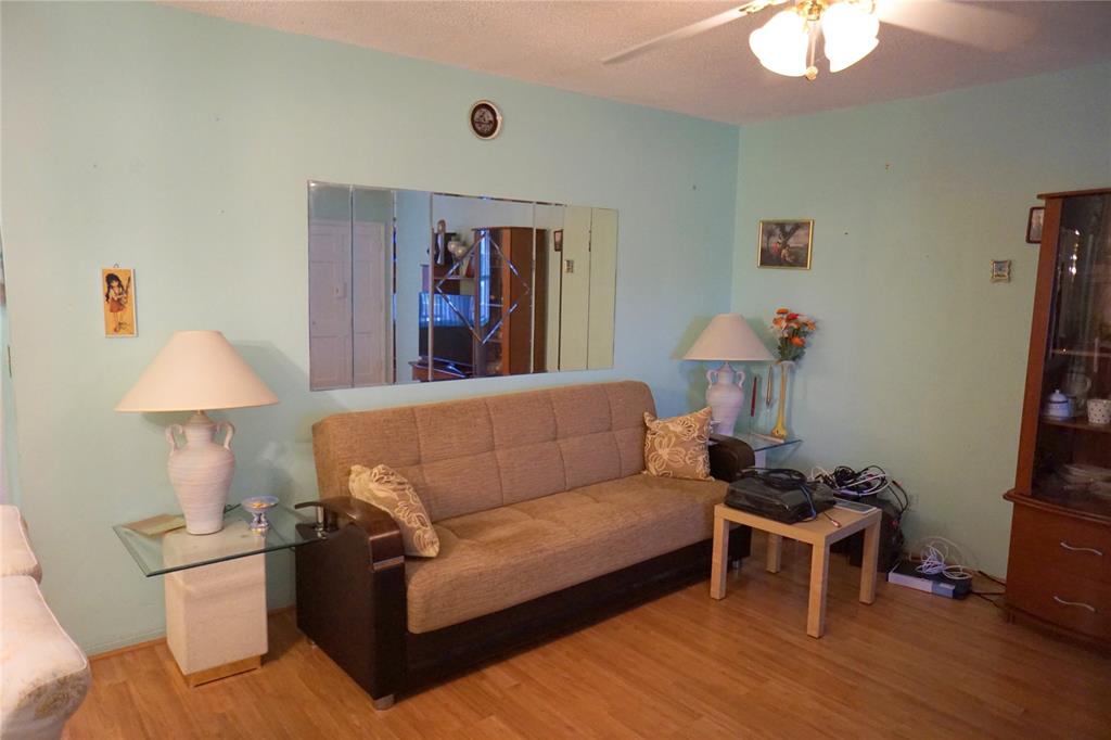 160 Northeast 8th Avenue, Unit 25B Hallandale Beach, FL 33009 - Photo 17 of 35 a living room with furniture and a flat screen tv