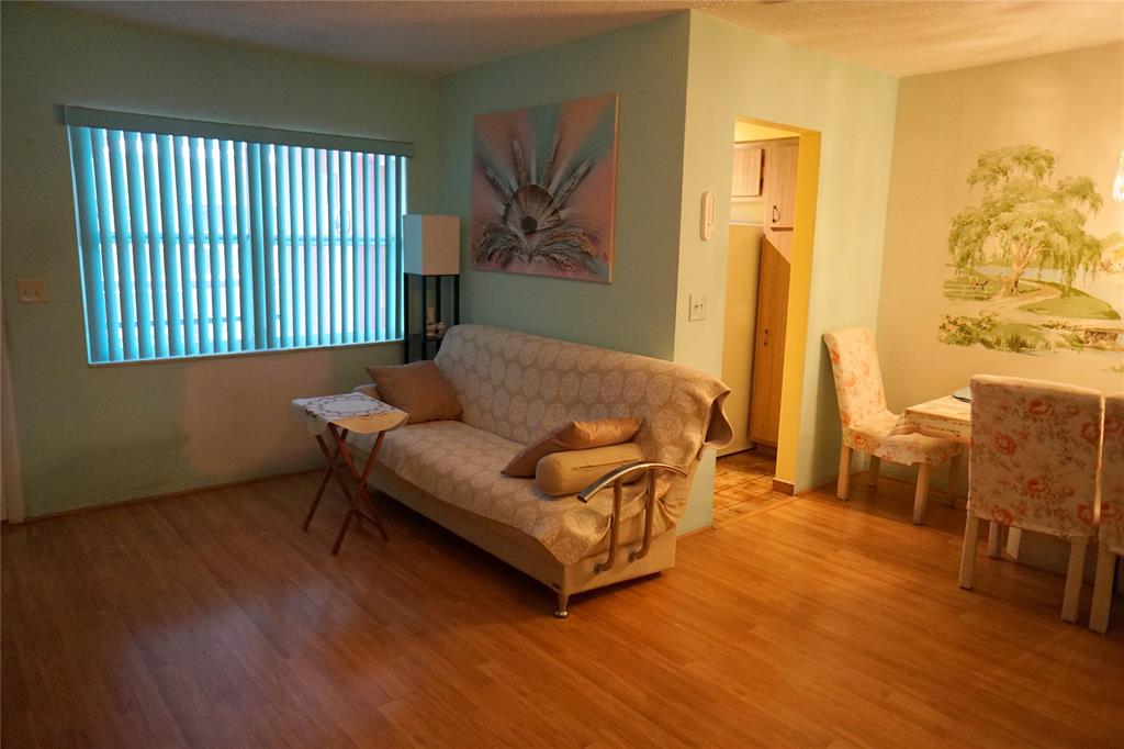 160 Northeast 8th Avenue, Unit 25B Hallandale Beach, FL 33009 - Photo 18 of 35 a living room with furniture and a window