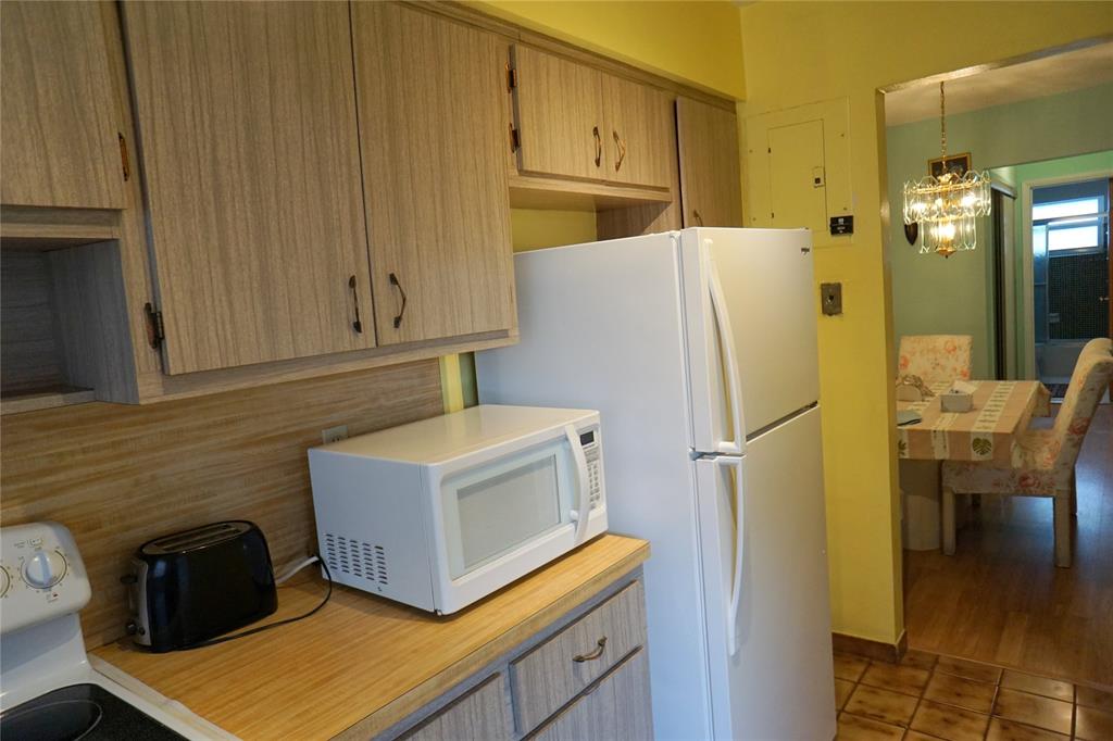 160 Northeast 8th Avenue, Unit 25B Hallandale Beach, FL 33009 - Photo 20 of 35 a kitchen with stainless steel appliances a refrigerator sink and cabinets