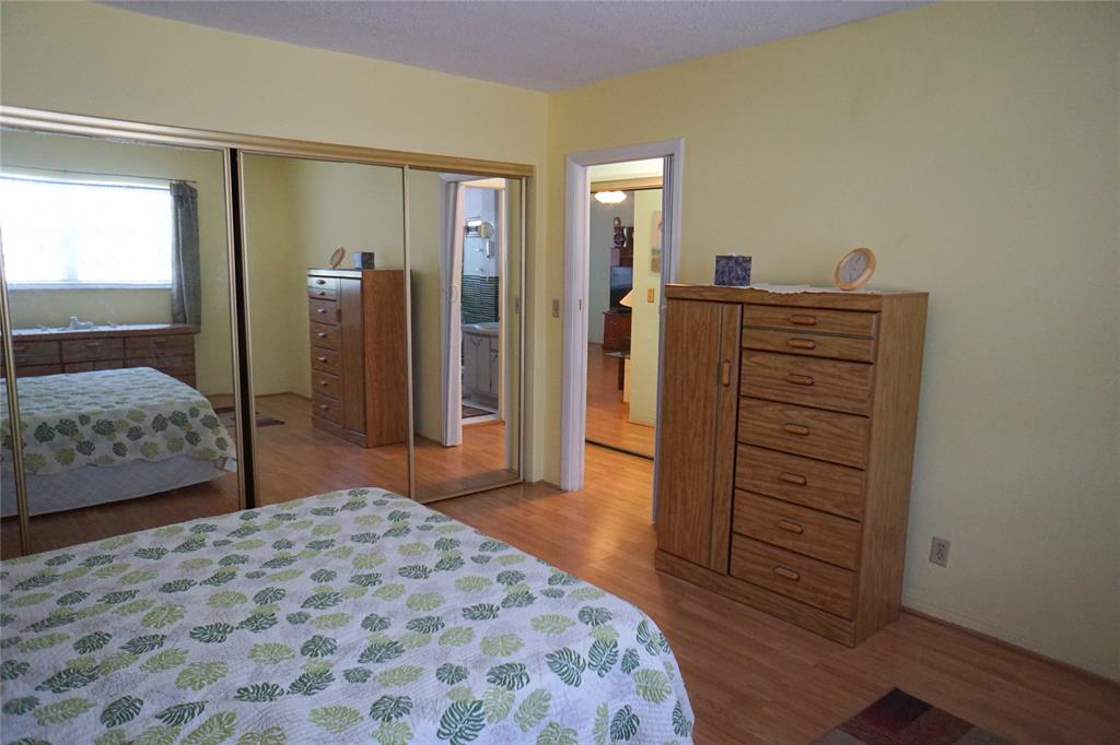 160 Northeast 8th Avenue, Unit 25B Hallandale Beach, FL 33009 - Photo 26 of 35 a bedroom with a bed and a dresser