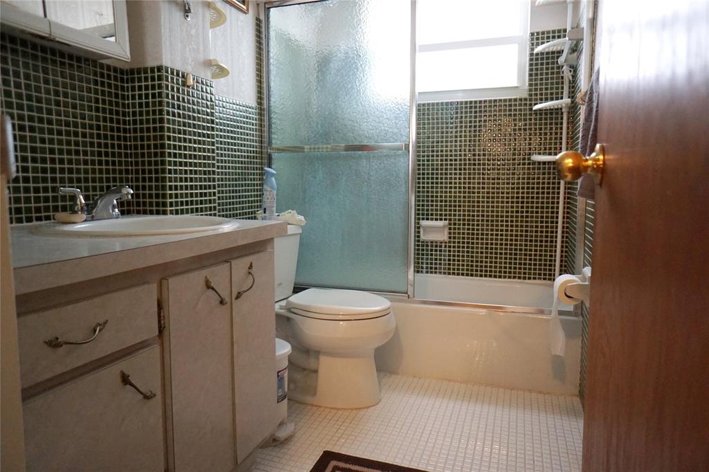 160 Northeast 8th Avenue, Unit 25B Hallandale Beach, FL 33009 - Photo 27 of 35 a bathroom with a toilet a sink and shower