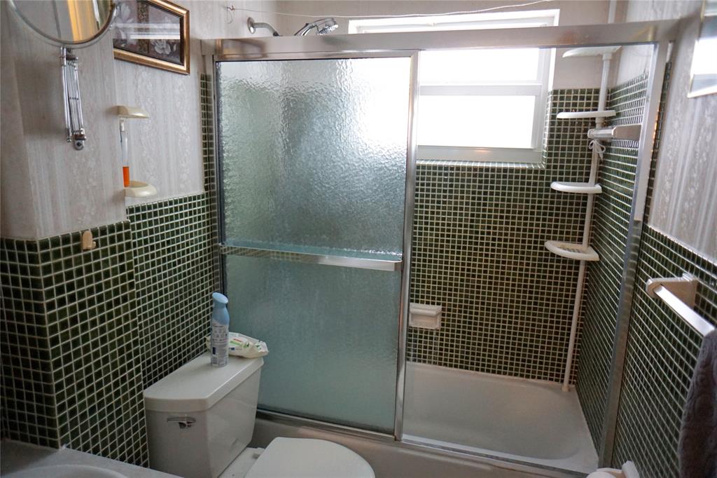 160 Northeast 8th Avenue, Unit 25B Hallandale Beach, FL 33009 - Photo 28 of 35 a bathroom with a toilet and shower