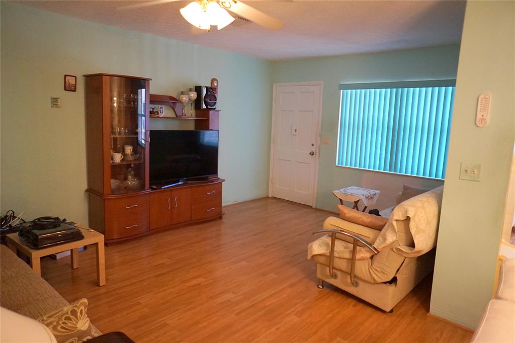 160 Northeast 8th Avenue, Unit 25B Hallandale Beach, FL 33009 - Photo 33 of 35 a living room with furniture and a flat screen tv