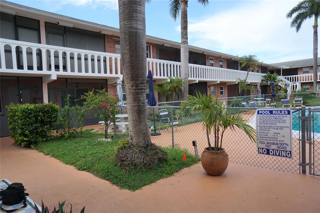 160 Northeast 8th Avenue, Unit 25B Hallandale Beach, FL 33009 - Photo 4 of 35 a view of a house with a yard