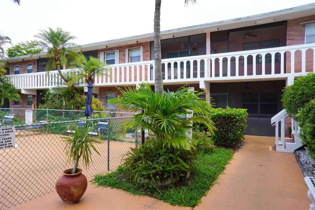 160 Northeast 8th Avenue, Unit 25B Hallandale Beach, FL 33009 - Photo 8 of 35 a view of a house with backyard and sitting area