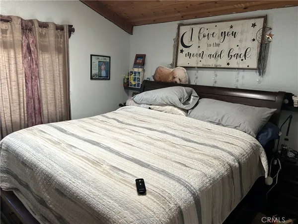 a bedroom with a bed and painting on the wall