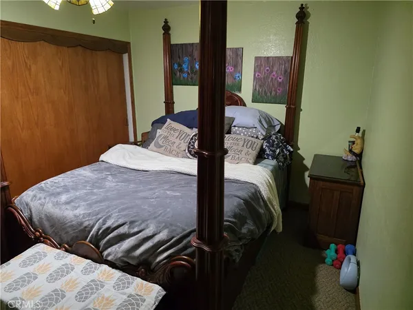 a bedroom with a bed and a table
