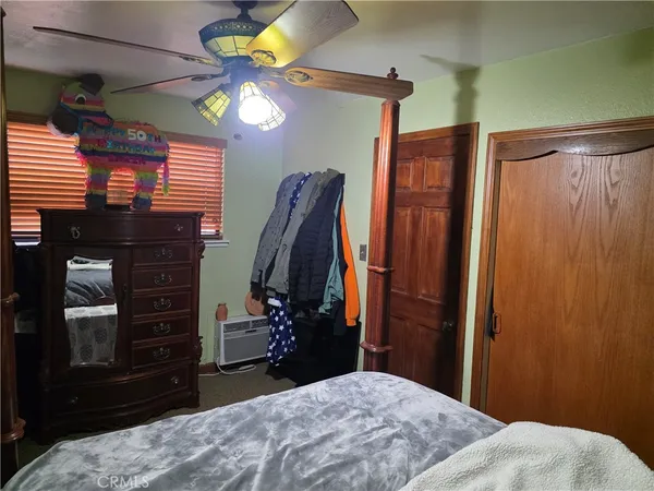 a bedroom with a bed dresser and a window