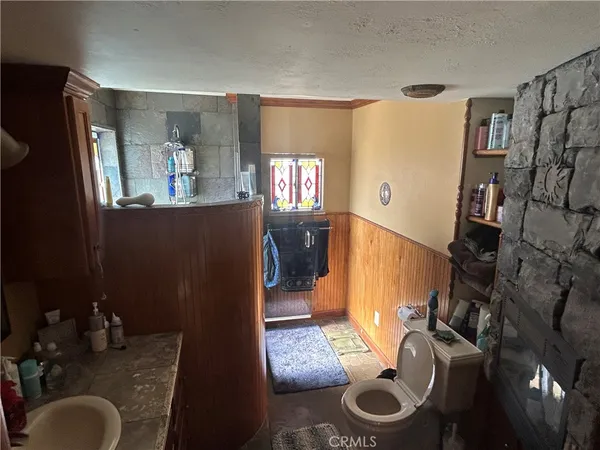 a bathroom with sink toilet and mirror