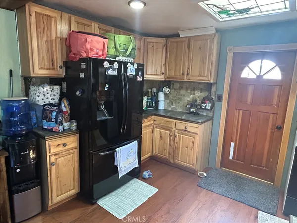 a kitchen with stainless steel appliances granite countertop a refrigerator and a stove