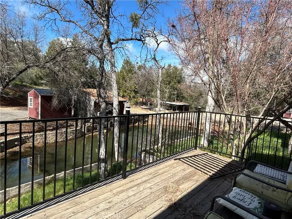 a view of balcony with wooden floor and fence