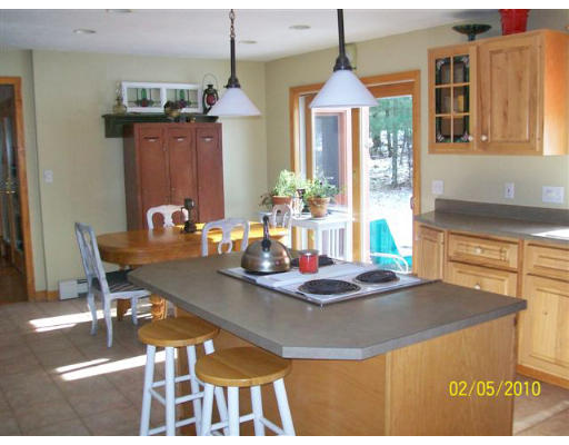 184 Hartness Road Sutton, MA 01590 - Photo 3 of 20 a dining room with furniture a chandelier and a dining table