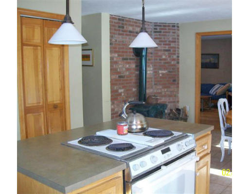 184 Hartness Road Sutton, MA 01590 - Photo 4 of 20 a kitchen table with a stove and a table