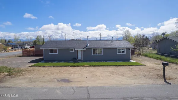 a aerial view of a house with a yard and a garage