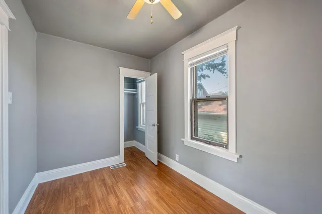 an empty room with windows and closet