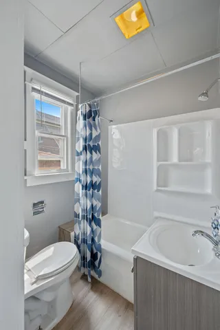 a bathroom with a toilet a sink and bathtub