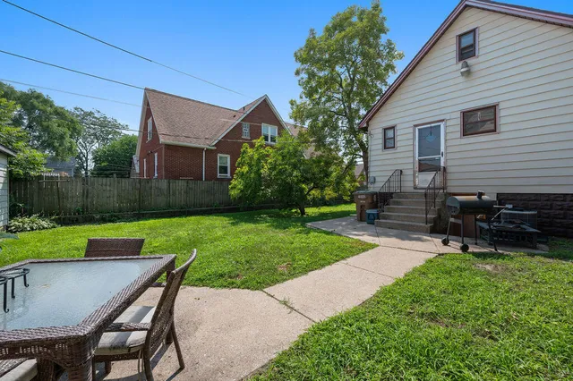 a view of backyard with seating and green space