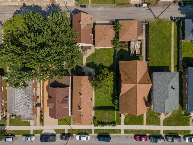 an aerial view of multiple houses with a yard