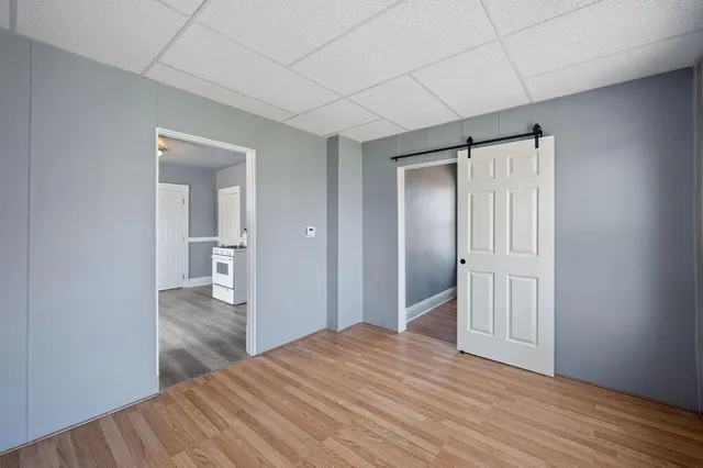 a view of hallway with wooden floor
