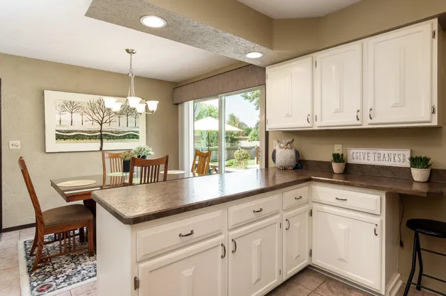 a kitchen with refrigerator and window