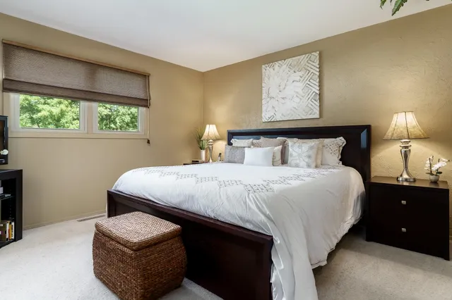 a bedroom with a bed and a lamp