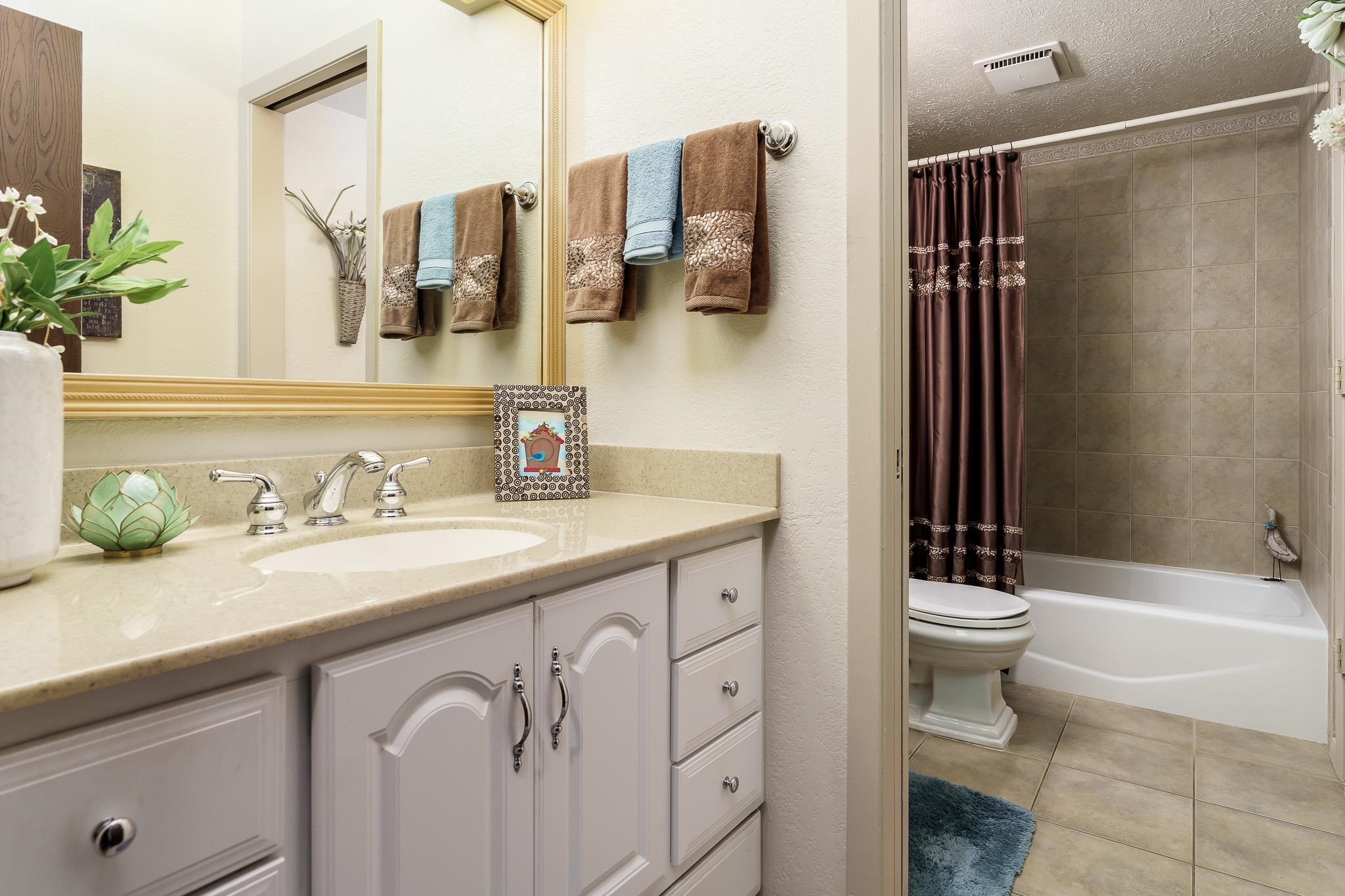 11748 Cedarbrook Road Roscoe, IL 61073 - Photo 21 of 50 a bathroom with a granite countertop sink and a mirror