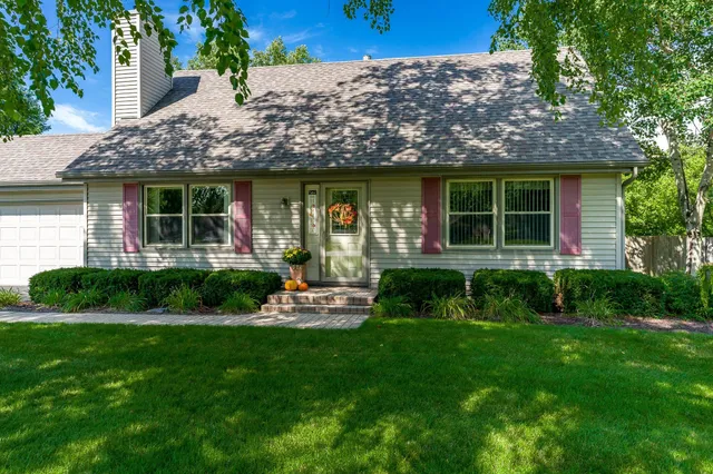 a front view of a house with a yard and outdoor seating